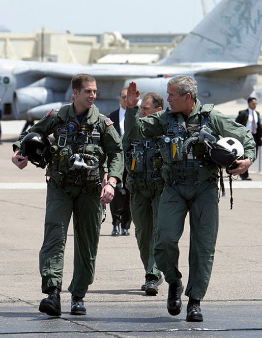 George W. Bush walks with Ryan Phillips to Navy One